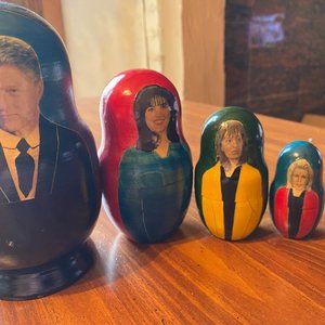 Russian wooden stock up nesting dolls: political satire on  and his women